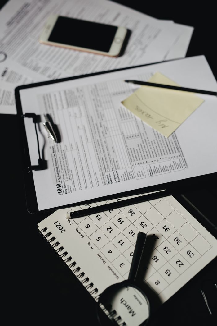 Top view of an organized workspace with documents, a calendar, and office supplies.